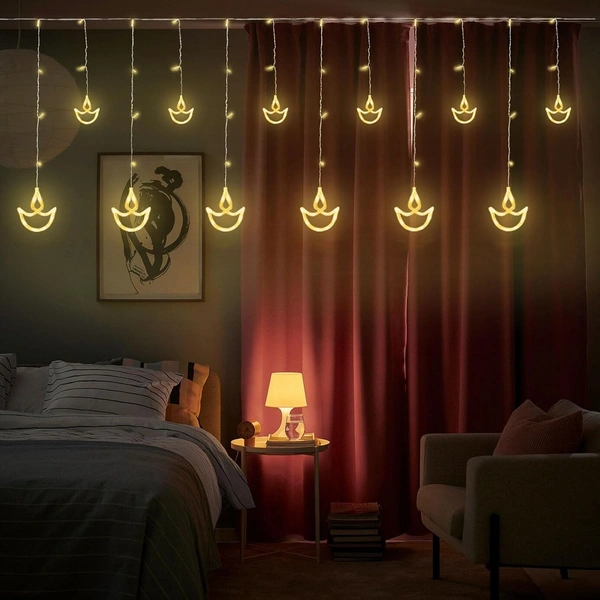 6+6 DIYA LIGHT WW, Diwali Diya String Lights – 12 Hanging Diyas, 8 Flashing Modes, USB & Battery Powered Warm White Decorative Lights for Wall, Window, Fence & Party Decor(42)