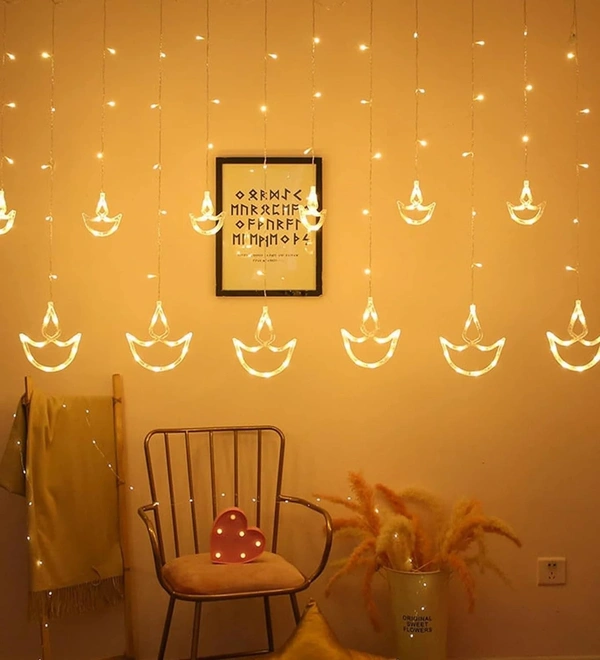 6+6 DIYA LIGHT WW, Diwali Diya String Lights – 12 Hanging Diyas, 8 Flashing Modes, USB & Battery Powered Warm White Decorative Lights for Wall, Window, Fence & Party Decor(42)