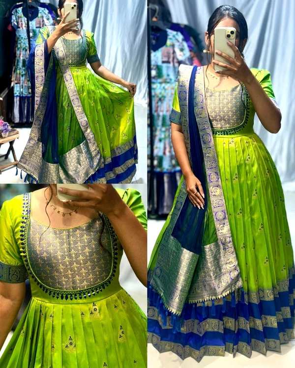Trendy silk gown, crafted with banarasi silk and golden zari weave.paired  with net duppta with zari border and decorated with mirror and work