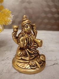 Buy Brass Lakshmi Idol Sitting On Round Base With Flowers