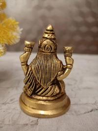 Buy Brass Lakshmi Idol Sitting On Round Base With Flowers