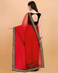 Net Red Lace border Saree With Blouse. Elevate your elegance with our exquisite Net Lace Saree, a perfect blend of sophistication and glamour. Crafted from high-quality net fabric, this saree features intricate lace detailing that exudes timeless charm. - Free Size