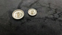 12 round metal buttons in gold and black. They have an embossed design and a shank on the back. Six buttons are larger, and six are smaller. These buttons can be used for coats, blazers, suits, sherwanis, and other Indian dresses. 