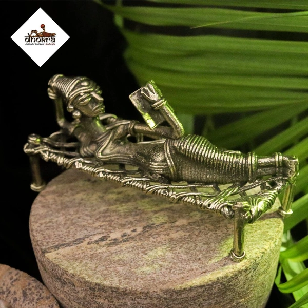 Dhokra Craft of a Tribal Woman Relaxing on Cot, Engrossed in a Book - Height 6 Inch