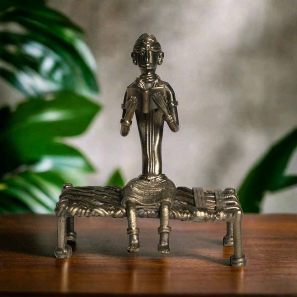 Dhokra Craft of a Tribal Woman Relaxing on Cot, Engrossed in a Book - Height 6 Inch