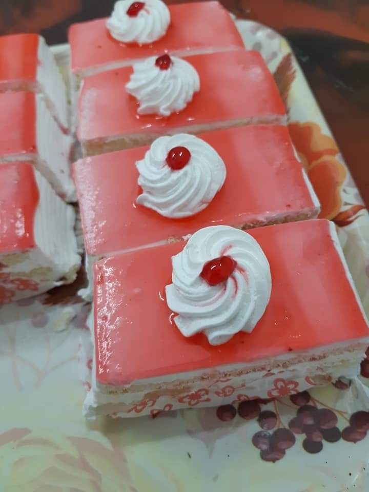 The pastry chef cut the cake. Strawberry yogurt cake. Consists of butter  sponge cakes,covered with cream-based live strawberry yoghurt. Filling :  fresh strawberries and strawberry confit. Insanely light and delicate cake  Stock
